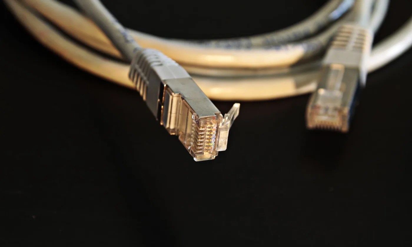 Copper Ethernet patch cables with clear RJ45 plugs and visible gold-colored contacts