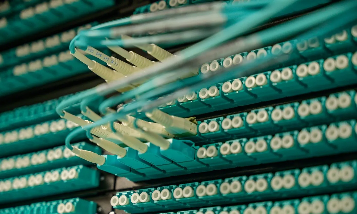 Fiber-optic patch cables connected to a network rack