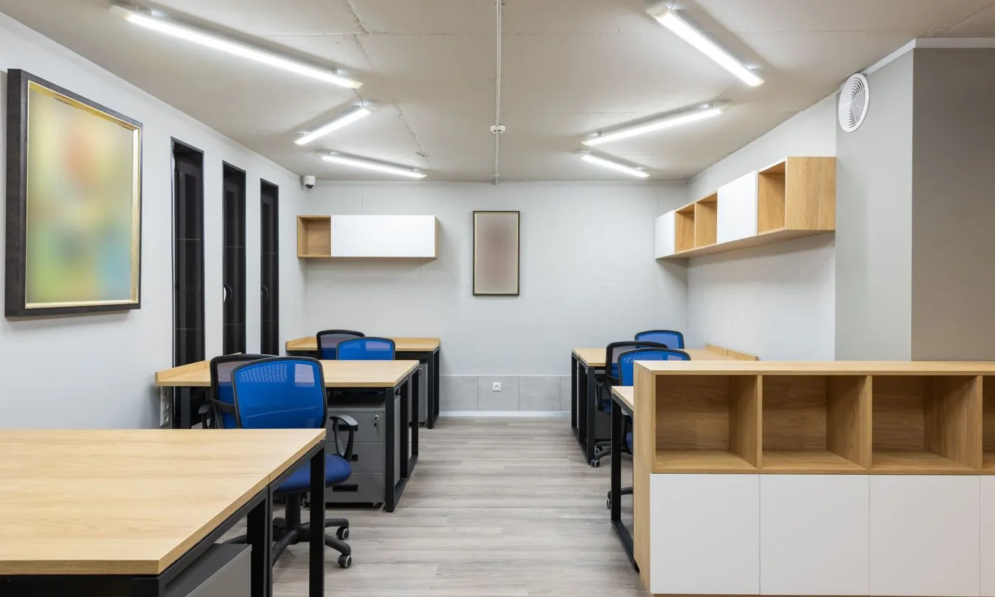 Modern office interior with desks and ceiling-mounted lighting