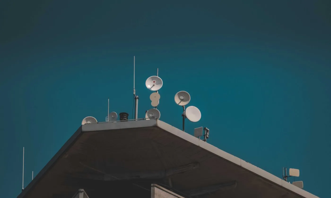 Communication antennas and dishes mounted above a building